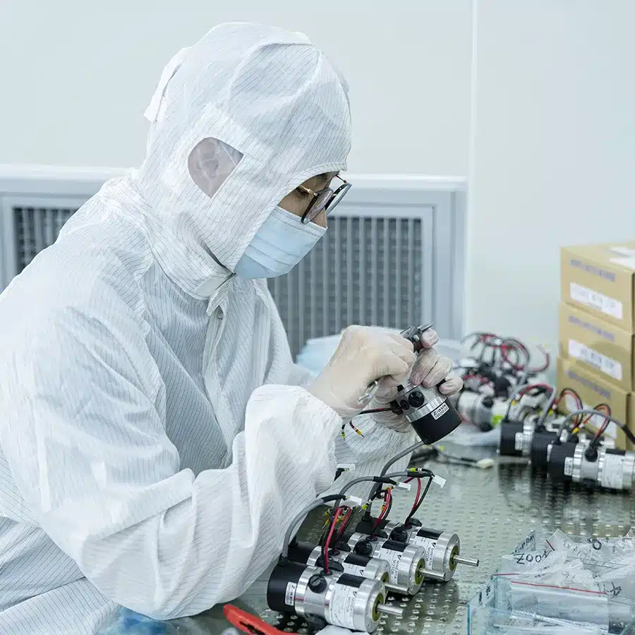 Technician assembling components for the semiconductor consumable market Technician in cleanroom assembling precision components for the semiconductor consumable market